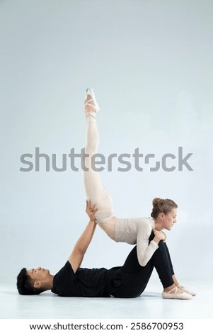 Similar – Image, Stock Photo Vertical composition. Ballerina in the studio at rehearsal. Spotlights and fog in blue tones. Sexually. No face