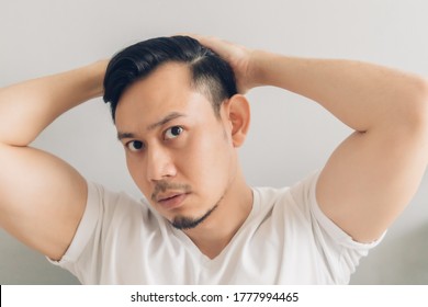 Asian Man Is Checking Out His New Haircut After Covid-19 Quarantine.