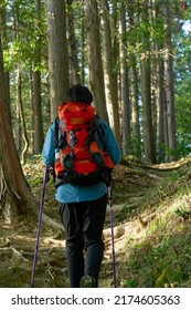 Asian Man Climbing A Mountain