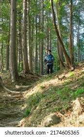 Asian Man Climbing A Mountain