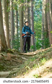 Asian Man Climbing A Mountain