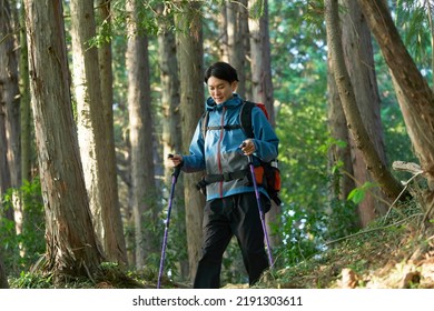 Asian Man Climbing A Mountain 