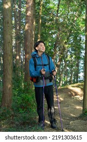 Asian Man Climbing A Mountain 