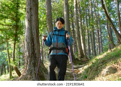 Asian Man Climbing A Mountain 