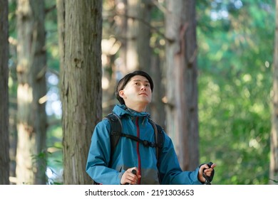 Asian Man Climbing A Mountain 