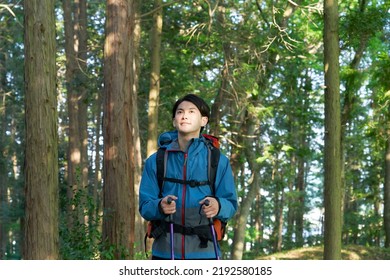 Asian Man Climbing A Mountain 