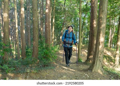 Asian Man Climbing A Mountain 