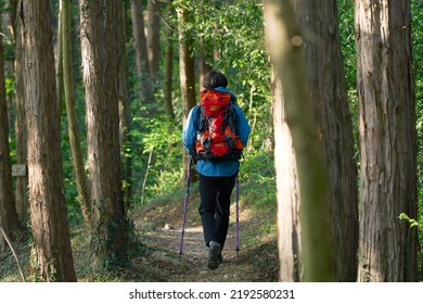 Asian Man Climbing A Mountain 