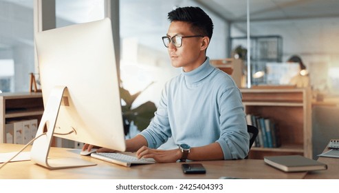 Asian man at computer, glasses and ideas, thinking and reading email, web review or article at digital agency. Research, reflection and businessman at tech startup networking on business website.