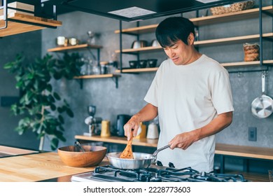 Asian man cooking in the kitchen