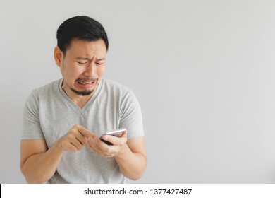 Asian Man Cry And Sad With What Show On The Smartphone.