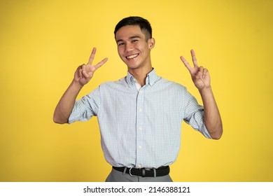 Asian Man With Cute Hand Gesture Making V Shape On Finger