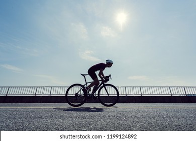 Asian Man Cycling Road Bike In The Morning