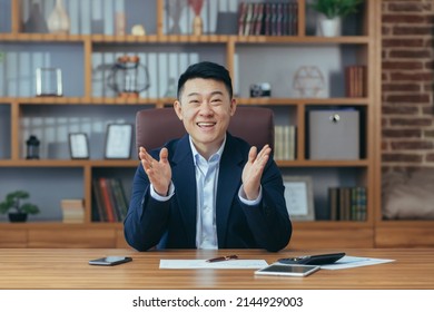 Asian Man Diplomat, Director, Businessman Looking At The Camera Smiling, Concluding A Contract, Holding A Meeting, Video Call Conference, Consults. Explains, Sits At A Table In The Office At Work