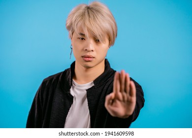 Asian Man Disapproving With NO Hand Sign Gesture. Denying, Rejecting, Disagree, Portrait Of Handsome Korean Guy Or Student On Blue Background