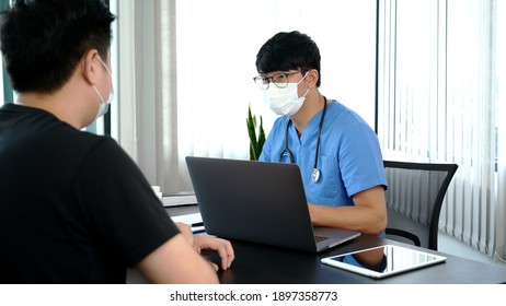 Asian Man Doctor Wear Protection Face Mask During Coronavirus And Flu Outbreak Is Taking Care Examining Sick Patient In Hospital.