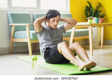 Asian Man Doing Exercise At Home
