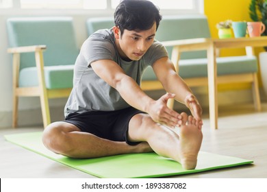 Asian Man Doing Exercise At Home
