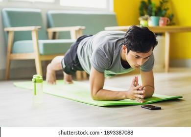 Asian man doing exercise at home
