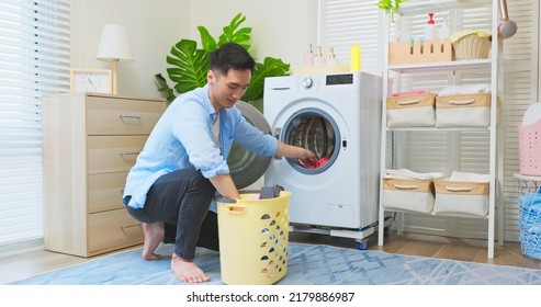 Asian Man Doing Laundry - He Put Clothes Into Washing Machine