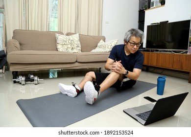 The Asian Man Doing Workout In The Living Room.