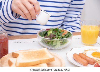 Asian Man Dressing A Large Salad