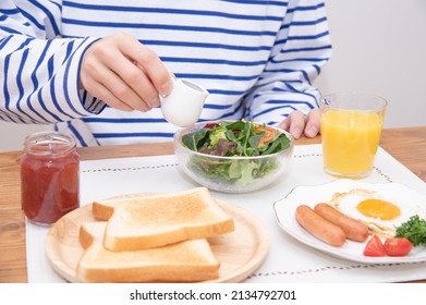 Asian Man Dressing A Large Salad