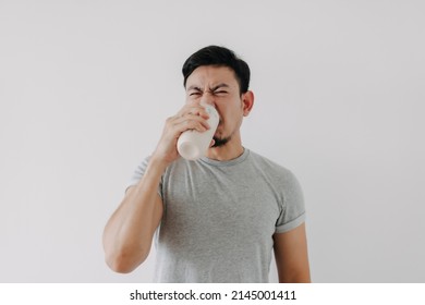 Asian Man Drink Bad Taste Of Protein Chicken Shake For Health Isolated On White.