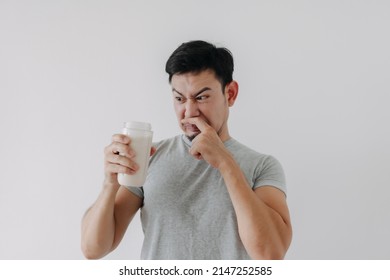 Asian Man Drink Bad Taste Of Protein Chicken Shake For Health Isolated On White.