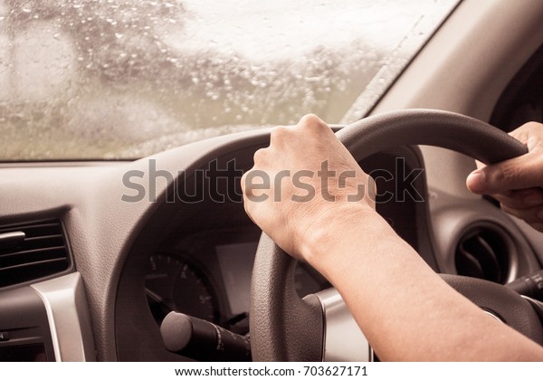 Asian man\
driver car in rainy day vintage\
tone.