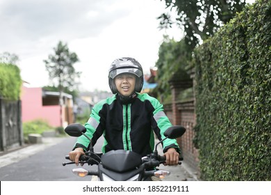 Asian Man Driver Grab With Helmet Using Motorcycle Rider. November 10, 2020. Jakarta Indonesia
