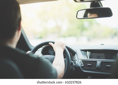 Asian Man Driving A Car