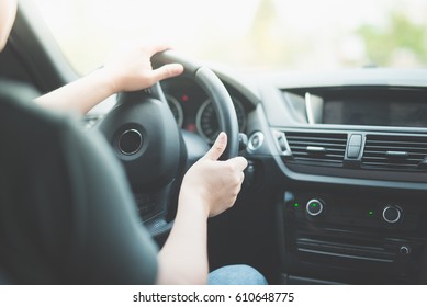 Asian Man Driving A Car