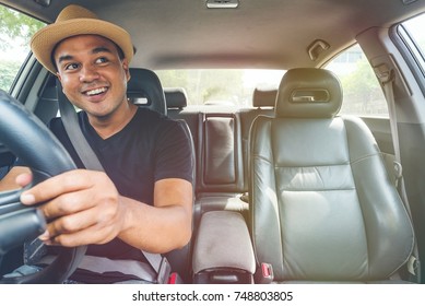 Asian Man Driving Car And Look Back.