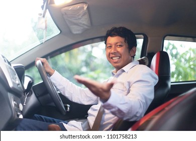 asian man driving car to travel or grab, gocar and uber. Asian man driving car and showing hand. yogyakarta indonesia. may 31, 2018