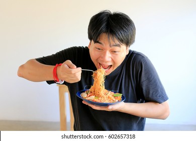 Asian Man Is Eating Delicious Instant Noodle.