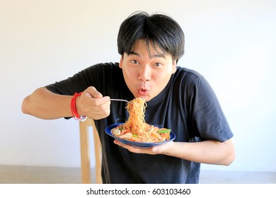 Asian Man Is Eating Delicious Instant Noodle.