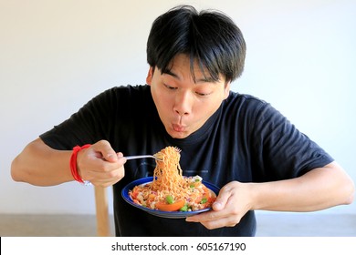 Asian Man Is Eating Delicious Instant Noodle.