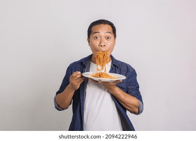 Asian Man Eating A Lot Of Instant Noodles And Feel Surprise With How Delicious It Is