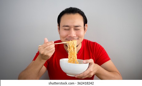 Asian Man Eating Instant Noodles.