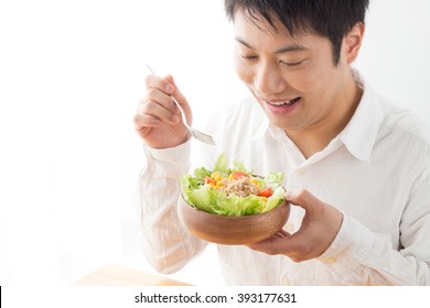 Asian Man Eating Salad