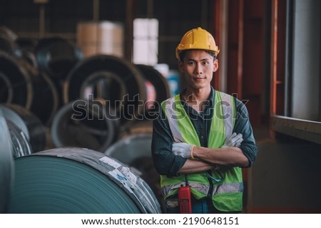Asian man engineer  working hard in factory , worker employee  hard hat safety control machine factory 