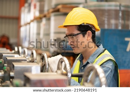 Asian man engineer  working hard in factory , worker employee  hard hat safety control machine factory 