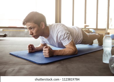 Asian Man Exercise In The Gym, He Doing A 