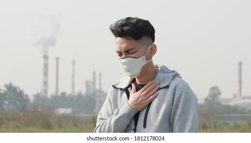 Asian Man Feel Pain On Lung And Wears Protective N95 Mask Because Air Pollution Standing In Front Of Factory