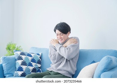 Asian Man Feeling Cold At Home