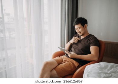 Asian man feels happy with his business while on his vacation trip. - Powered by Shutterstock