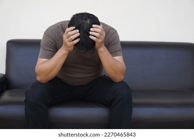Asian man feels sad, stressed, depressed, hands covered his head. Concept, drepression, failure, disappointment, broken heart. guilty, have life problems.                                         - Shutterstock ID 2270465843