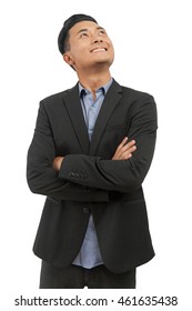 Asian Man In Formal Black Suit And Blue Shirt Standing With Folded Hands Looking Up And Smiling. Concept Of Business Decision Making. Isolated. Mock Up