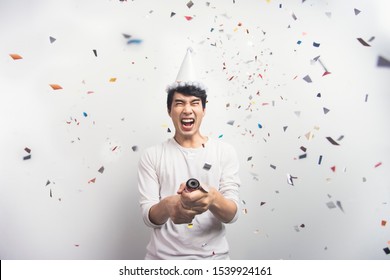 Asian Man Fun Celebrating Christmas Or New Year Party Confetti. Happy New Year Concept.